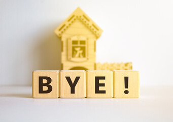 Bye symbol. Concept word Bye on beautiful wooden blocks. Beautiful white table white background. Wooden beautiful house. Business and bye concept. Copy space.