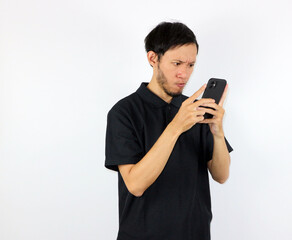 Man Looking Intently at Smartphone Screen Showing Concentration and Focus