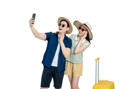 portrait of asian couple wearing travel clothes, suitcases and using phone  posing on white background