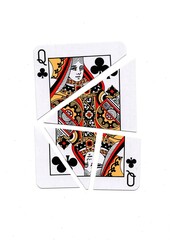 A playing card in the suit of clubs cut into sharp pieces.