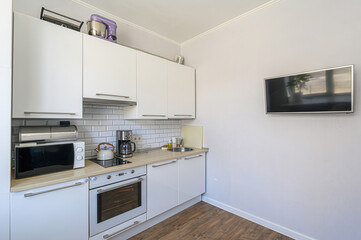 Fototapeta premium interior apartment kitchen and dining room, refectory area, cooking equipment, table furniture, stove