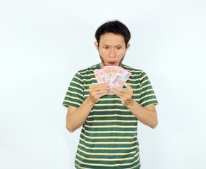Holding Money Man Looking Surprised Isolated Against White Background Studio