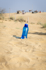 drinking water bottle kept at desert open heat at bright daylight