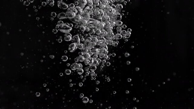 Super Slow Motion Shot of Air Bubbles Stream in Water, Isolated on Black at 1000fps.