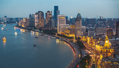 Aerial view of Shanghai illuminated skyline and river at night. © zhao dongfang