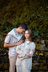Embracing Teen Love in the Greenery of the Park.