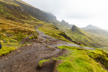 The Quiraing, Isle of Skye lush green landscapes, pure air, dramatic cliffs. A surreal trail through wild nature, perfect for trekking, silence, breathing untouched beauty, mystical rock formations.