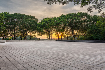 Tranquil Urban Park at Sunset Surrounded by Lush Trees