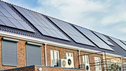 Contemporary residence features an air source heat pump installed outdoors alongside sleek black solar panels, harnessing sun energy for efficient eco-friendly living in the Netherlands.