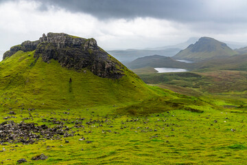 The Quiraing, Isle of Skye lush green landscapes, pure air, dramatic cliffs. A surreal trail through wild nature, perfect for trekking, silence, breathing untouched beauty, mystical rock formations.