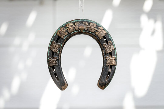 Hanging Antique Horseshoe With Floral Design Symbolizing Good Luck And Tradition