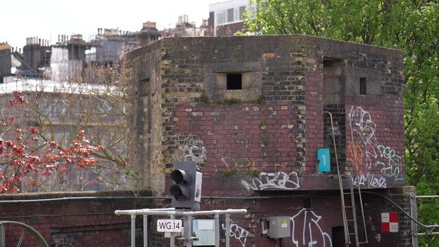 World War 2 pillbox and train passing at Putney Bridge tube station, London