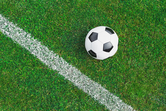 a soccer ball on the green grass on the line in soccer stadium.