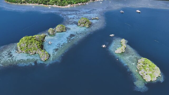 4K Drone View Of Seven Islands of Siete Pecados, Coron island, Palawan, Philippines
showcases the cluster of seven distinct islands surrounded by vibrant blue and crystal clear waters
