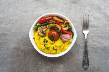 Delicious dietary dishes with grilled vegetables and porridge. Italian polenta with vegetables.