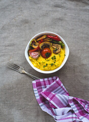 Delicious dietary dishes with grilled vegetables and porridge. Italian polenta with vegetables.