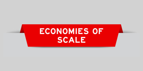 Red color inserted label with word economies of scale on gray background