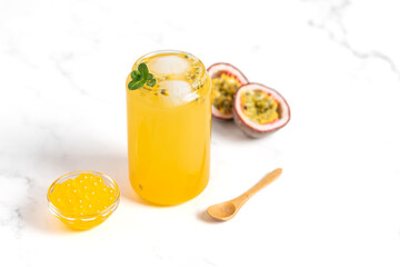 tropical Bubble Tea, Isolated on White Background. Colorful, Fresh Orange Boba Drink with Fruit Fizzy Jellies and Ice Cubes. Tapioca pearls. 