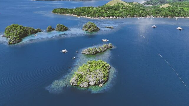 4K Drone View Of Seven Islands of Siete Pecados, Coron island, Palawan, Philippines
showcases the cluster of seven distinct islands surrounded by vibrant blue and crystal clear waters
