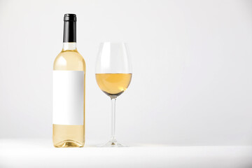 Tasty wine in glass and bottle on white background, space for text
