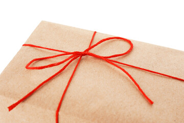 Gift wrapped in kraft paper with bow isolated on white