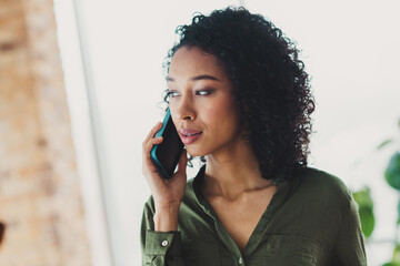 Confident Professional Woman Engaged in a Business Call in a Bright Office Environment