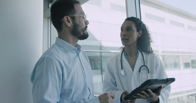 Doctor and Pharmaceutical sales representative talking in Hospital office