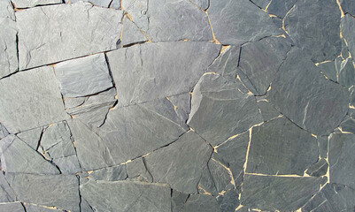 Gray volcanic stone wall of old house in Tenerife,
Canary Islands,Spain.Natural stones texture for design.
