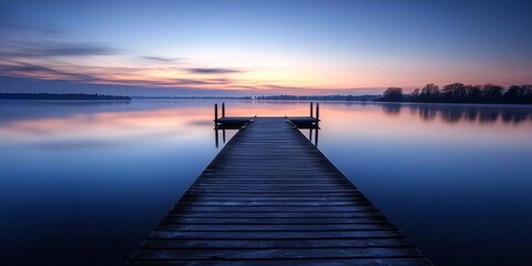 Fototapeta premium Peaceful lakeside landscape featuring a wooden dock