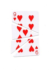 A playing card in the suit of hearts cut into sharp pieces.