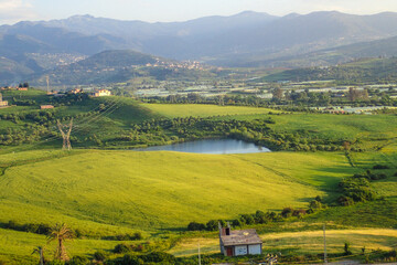 African countryside, Spring day landscape of fields, meadows and hills with mountains in the...