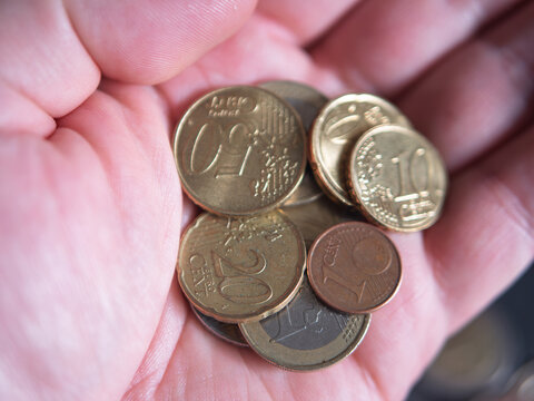 Coins in Hand Representing Savings and Financial Management
