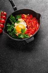 Fried egg tomatoes shakshuka vegetable dish appetizer fresh delicious gourmet food background on the table rustic food top view copy space vegetarian  food