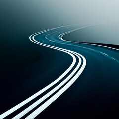 A winding road with white lines, creating a sense of journey through misty surroundings.