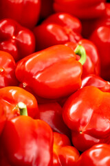 A bunch of red peppers are piled on top of each other