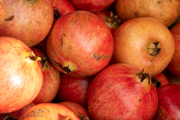 A bunch of red and orange pomegranates
