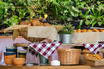 A breakfast table in hotel with a variety of breads and pastries, including croissants and bagels