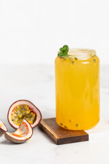 tropical Bubble Tea, Isolated on White Background. Colorful, Fresh Orange Boba Drink with Fruit Fizzy Jellies and Ice Cubes. Tapioca pearls. 