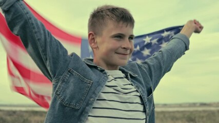 Young boy waving large american flag, standing in golden sunlight, displaying national pride with innocent enthusiasm.Usa celebrate 4th of july. Independence day concept