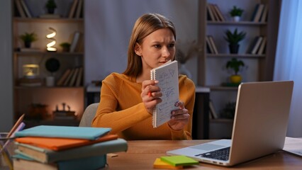 Focused Student Studying Mathematics with a Laptop at Desk