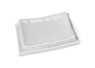 Stack of silky bed linens on white background