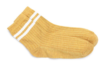 Pair of dark yellow socks isolated on white, top view