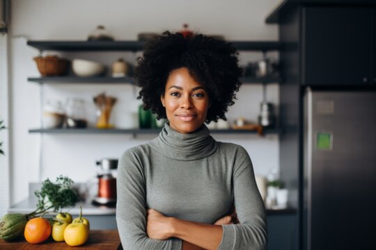 portrait of a african american middle age fitwoman standing infront of open fridge with healthy food with slightly messy modern apartment in the background in usa