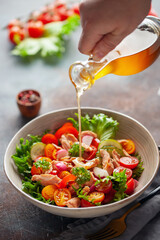 Salad with grilled salmon, fresh green  leaves, cucumber, tomatoes, sweet pepper and radish. Healthy lunch salad in bowl.