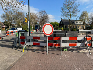 Road sign and barricade on city street