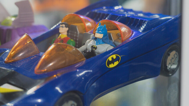 GUAYAQUIL, ECUADOR - AUG 06, 2023: Collectible model of the classic Batmobile with Batman and Robin figures inside, displayed at a geek store. An icon of the DC Comics universe and retro collectibles.