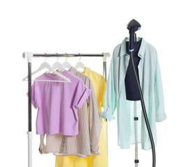 Modern upright steamer and clean clothes isolated on white