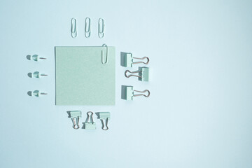 Colored stickers and paper clips on a colored background. Office supplies. Space for text and information