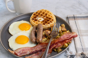 fried eggs with waffles  top with melted butter and  syrup