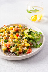 This healthy salad combines boiled millet, chickpeas, fresh vegetables, and avocado, all drizzled with olive oil for a nutritious and flavorful vegetarian meal